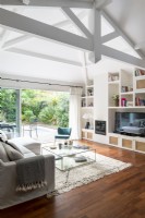 Modern living room with open patio doors to garden