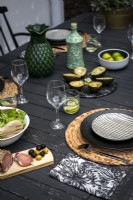 Detail of outdoor dining table laid for lunch 
