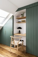 Built in Skandinavian style desk, home office, storage with shelves in loft bedroom, painted green