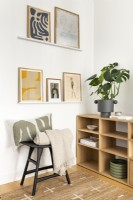 Scandinavian minimal contemporary living room, black and oak colour furniture, open shelves and wall art