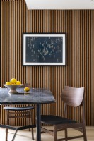 Modern mid-century dining table and chairs, with a slatted wall, Japandi style