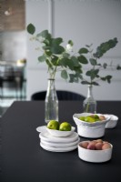 Bowls of fruit on modern black dining table 