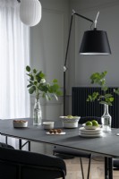 Modern dining table with large black floor lamp
