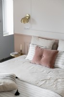 Pink cushion on bed in modern bedroom 