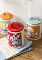 Retro style tea, coffee and sugar storage jars in kitchen - detail