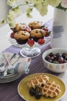 Cakes and fruit on dining table - detail 