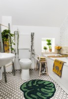 Modern white bathroom with green and yellow accessories 