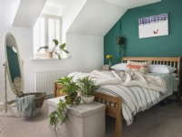 Green painted feature wall in modern bedroom