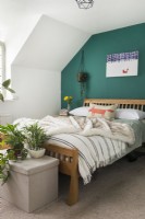Modern bedroom with green painted feature wall
