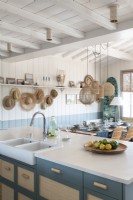 Blue and white country kitchen-diner in coastal cabin