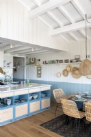 Blue and white kitchen-diner in coastal cabin