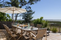 Outdoor dining area with coastal views in summer 