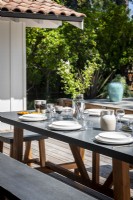 Outdoor dining table laid for lunch in summer