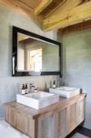 Twin sinks on wooden unit in modern country bathroom