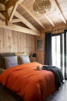Orange bedding in modern country bedroom