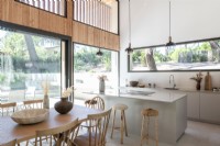Modern kitchen diner with view to garden through large windows