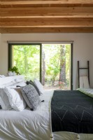 Modern country bedroom with view to woodland garden 