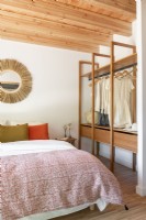 Open wardrobe - clothes rail in country bedroom
