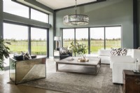 Modern living room with mirrored chair and views to countryside