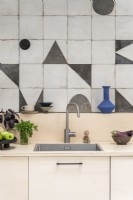 Modern kitchen sink with patterned tiled splashbacks