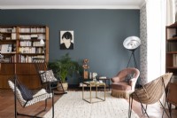 Modern living room with eclectic furniture and grey feature wall