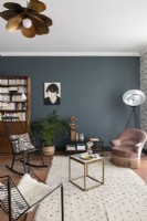 Modern living room with small chairs and grey painted feature wall