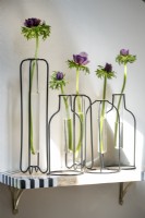 Modern decorative metal vase holders each with single flower
