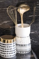 Black and white decorative utensil jars in kitchen - detail
