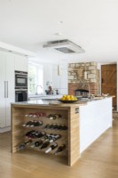 Large island with built-in wine rack in modern country kitchen