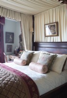 Four poster bed with canopy in classic bedroom