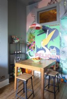Small table in colourfully decorated modern kitchen-diner
