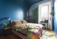 Colourful modern bedroom with mural painted around window