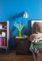 Salvaged bedside table in colourful modern bedroom