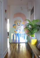 A colourfully painted mural on wall in hallway