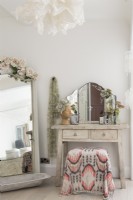 Shabby chic dressing table and mirror in feminine bedroom
