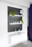 Contemporary white shelving and unit against grey painted wall
