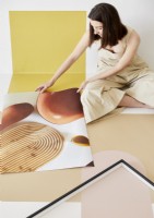 Woman using photographs to create decorative tabletop