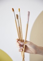 Woman holding artists brushes