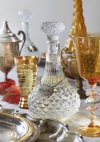 Detail of name tag around vintage crystal decanter on dining table