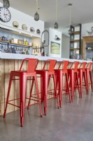 Red bar stools in modern kitchen