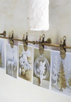 Detail of Christmas cards on pegs next to rustic window