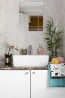White bathroom sink with tiled walls