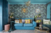 Retro style living room in teals and golds with palm patterned wallpaper