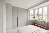 Modern bedroom with bay window and built in wardrobe

