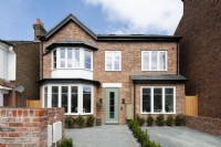 Modern brick house with paved forecourt