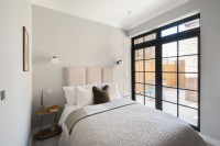 Modern bedroom with doors leading to patio terrace