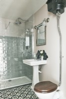 Traditional toilet cistern and sink in modern bathroom 