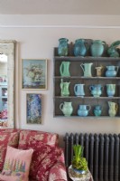 Simple shelving with blue and green vase collection, in comfortable country cottage