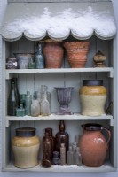 Outdoor shelves with a collection of vases, pots and jars