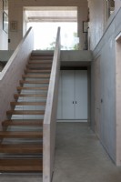 Contemporary Stairs in concrete and ply, hallway storage
